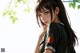 Anime girl with long black hair wearing a green shirt.