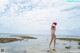 A woman in a bikini standing in the water.